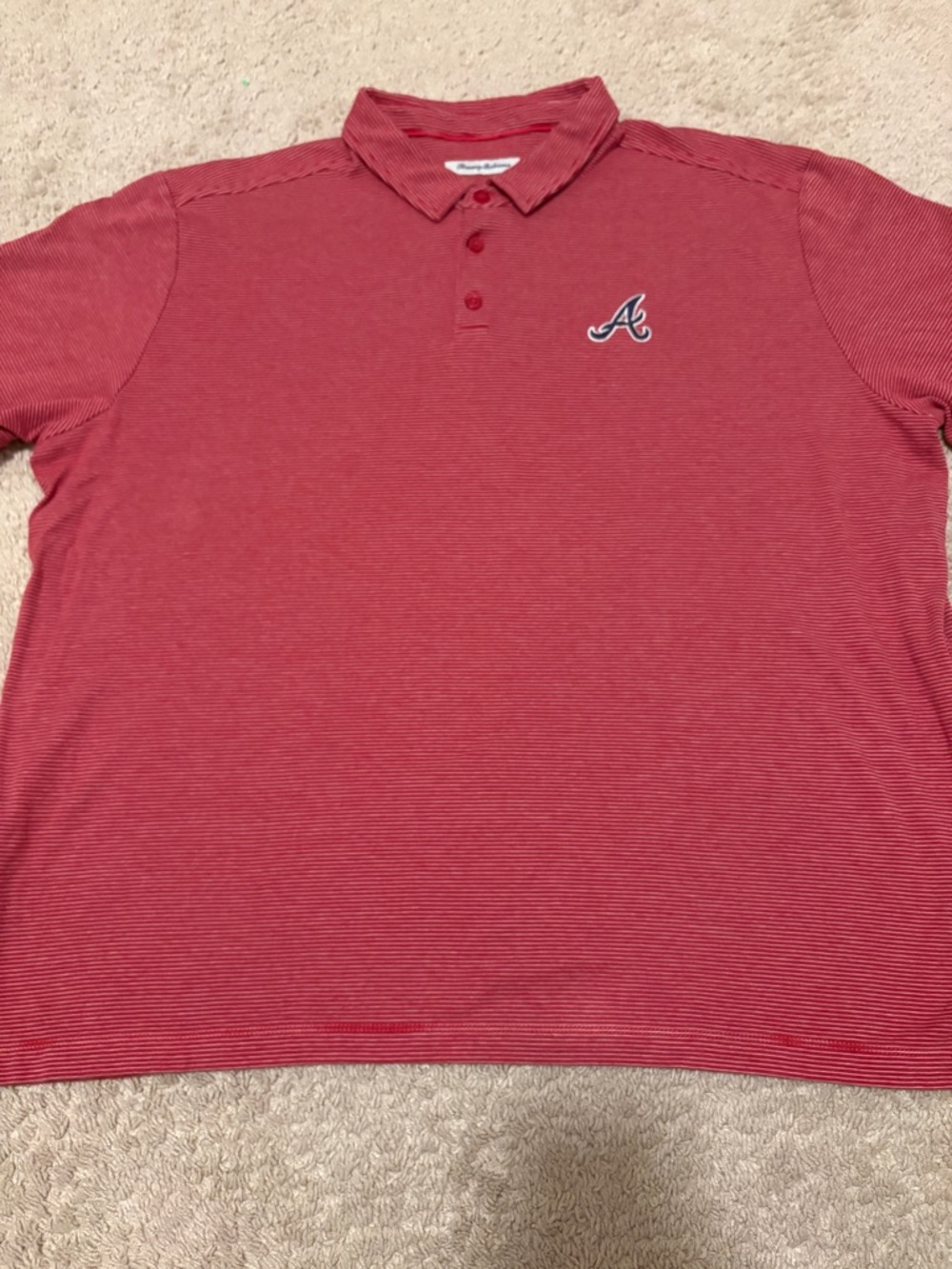 Tommy Bahama means polo shirt featuring Atlanta Braves embroidered logo.